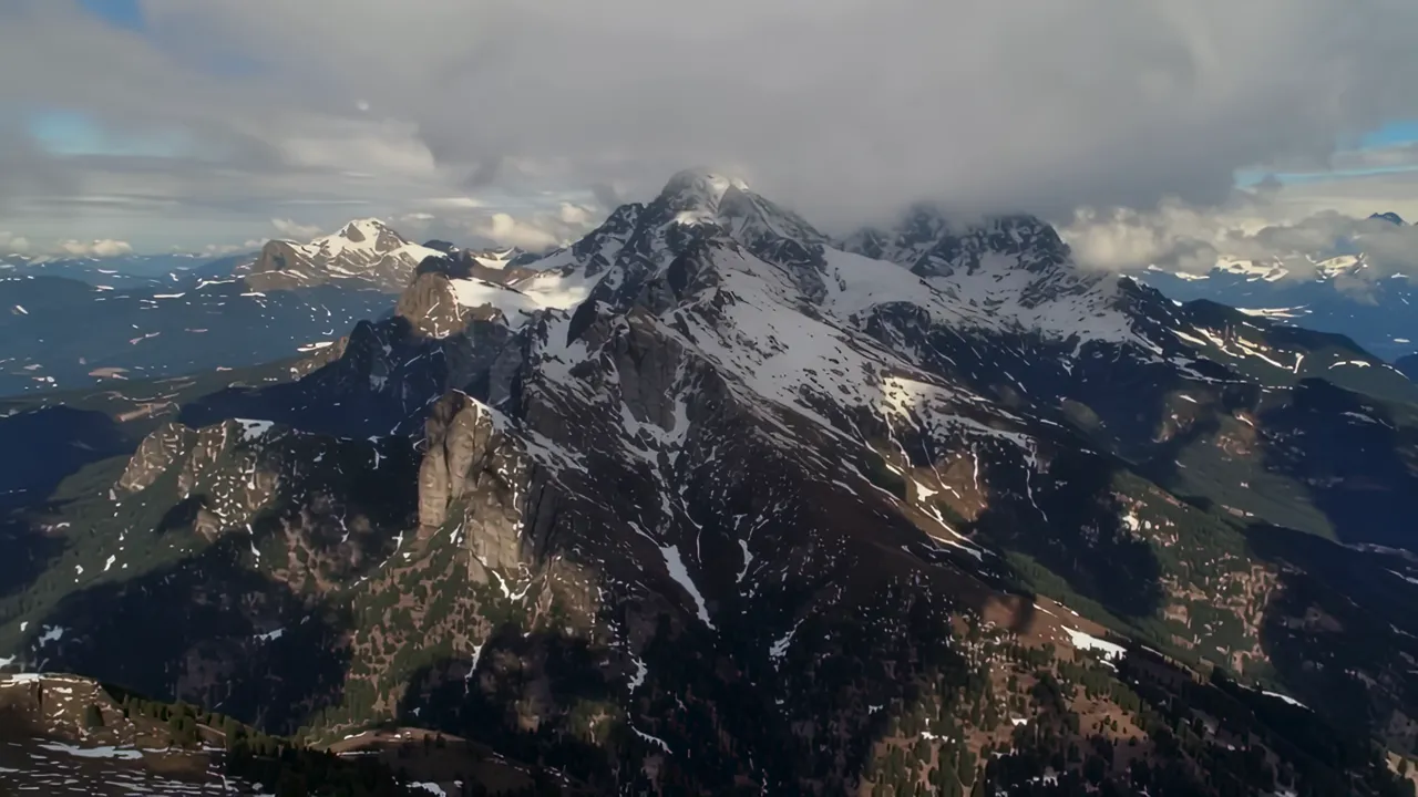 Aerial View of Mountain Range with Dramatic Cloud Shadows