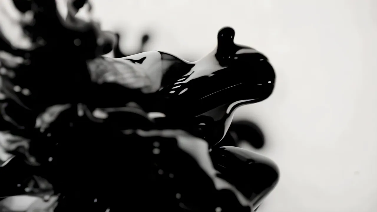 Black Ink Expanding Across a White Surface
