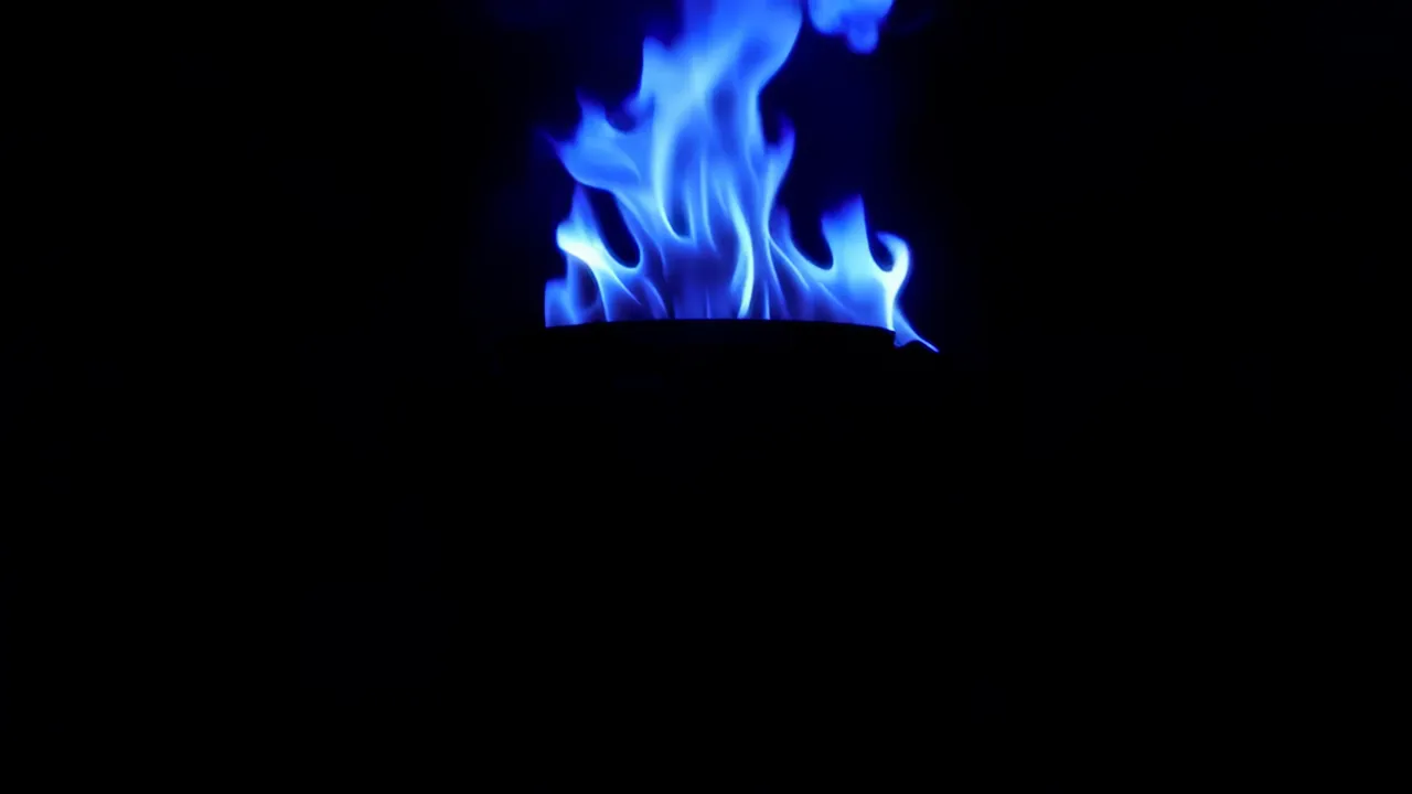 Blue Flames Licking and Spreading in Darkness