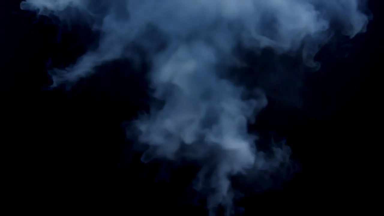 Burst of White Steam Expanding Against Black Background