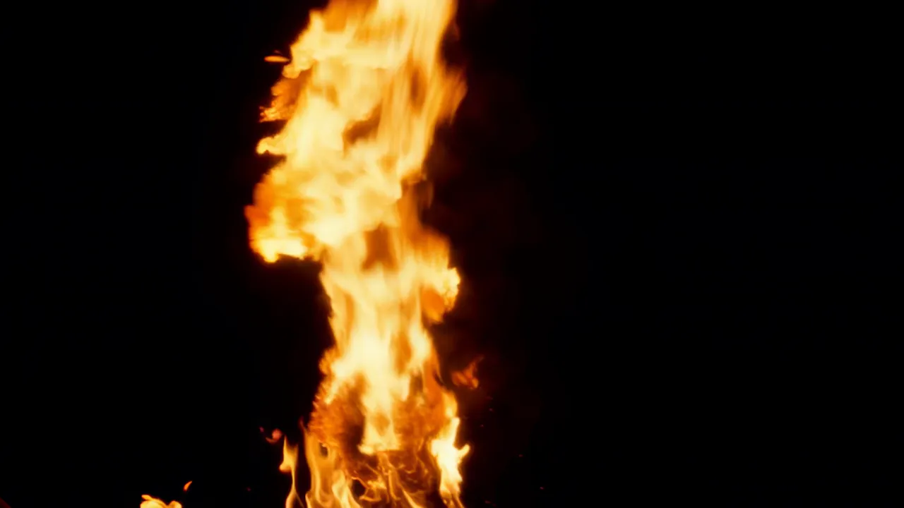 Cascading Fire Flowing Downward Against Black Background