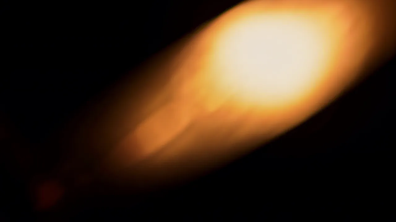 Diagonal Light Streak in Warm Orange and White on Black