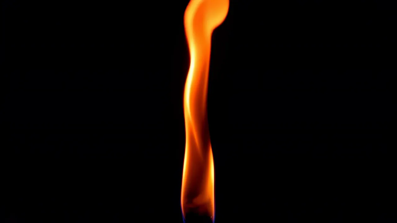 Elegant Flame Twisting Gracefully Against Black Background