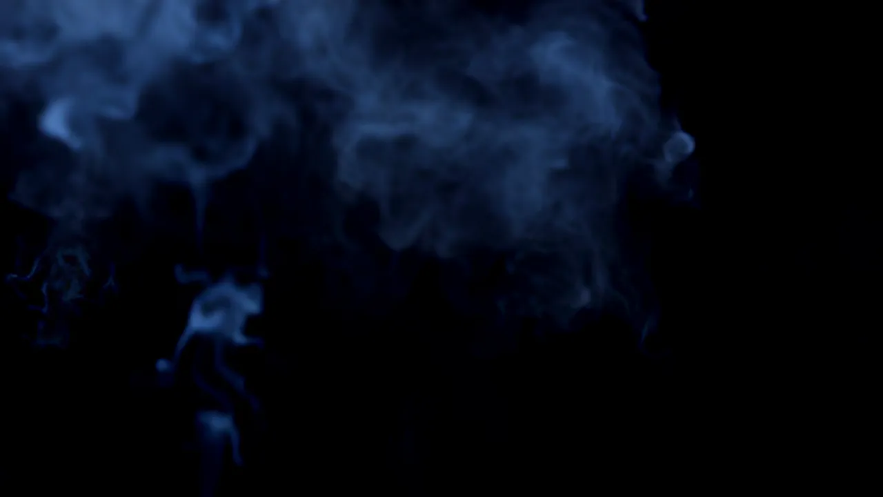 Expanding Blue Smoke Ring on Black Background