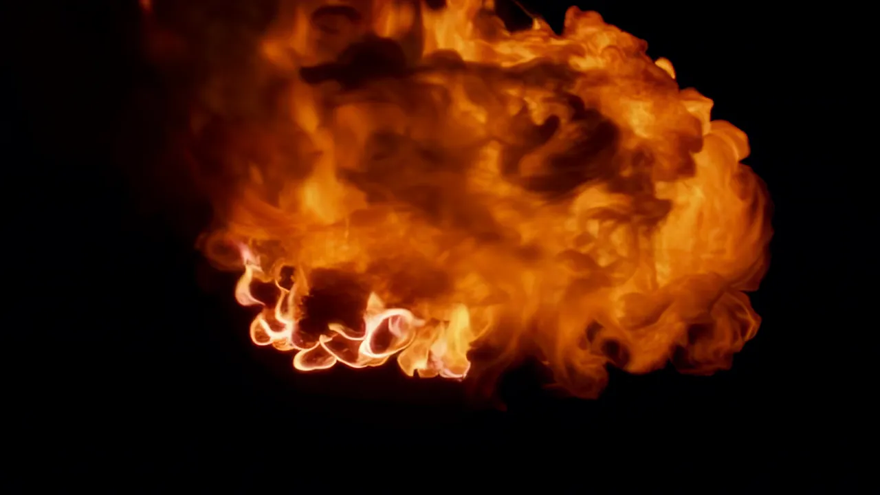 Fireball Expanding with Billowing Flames Against Black Background
