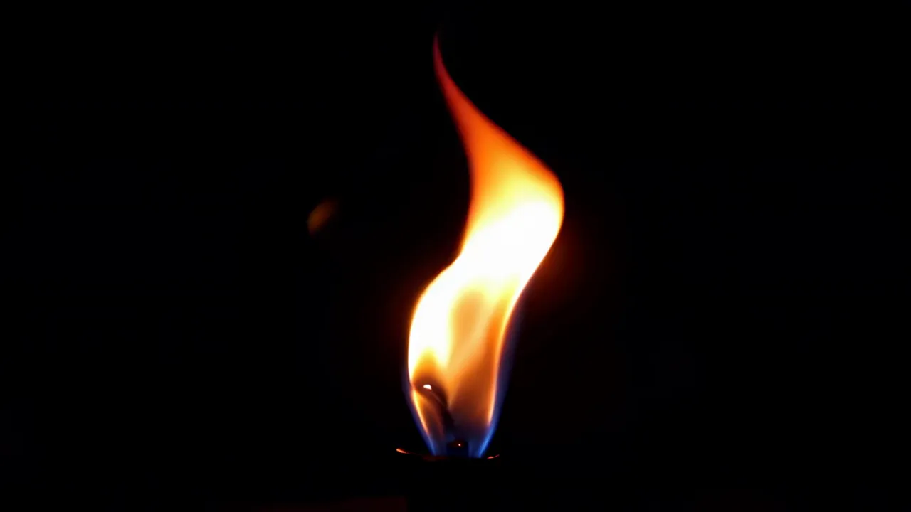 Flickering Candle Flame on Black Background