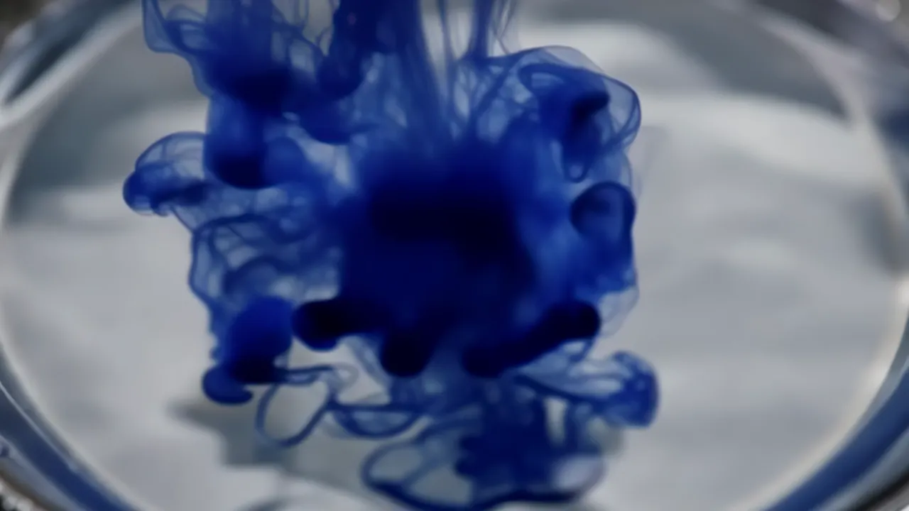 Ink Drop Falling into Water and Spreading Fluidly