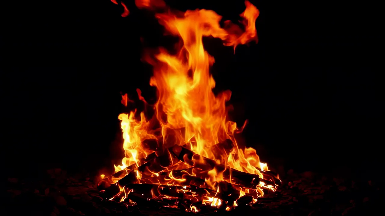 Intense Bonfire Flames Rising Against Black Background