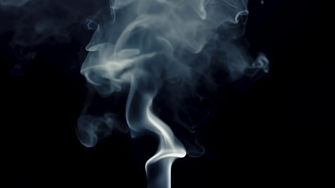 Pale Smoke Haze Diffusing Against Black Background