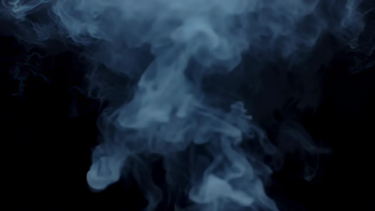 Pale Smoke Spreading Diffusely on a Black Background