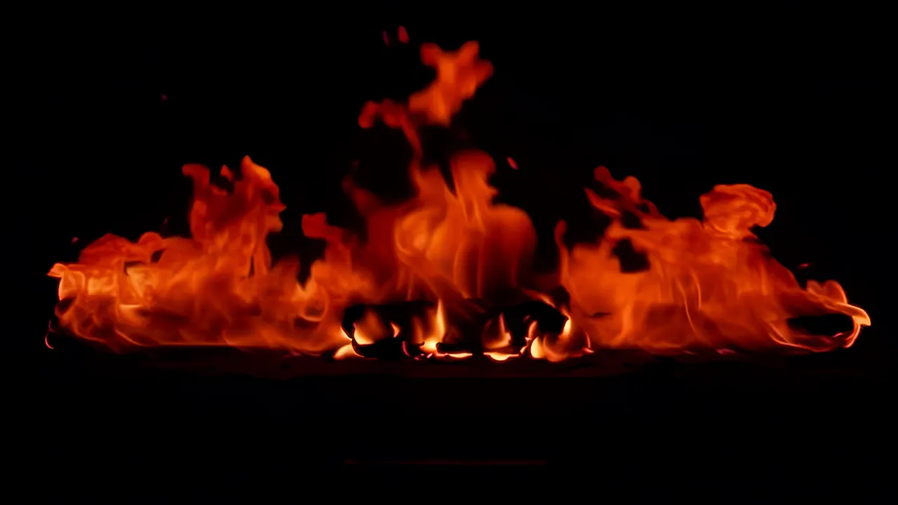 Slow Moving Flame Across Dark Background
