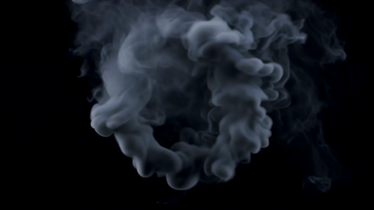 Smoke Ring Expanding and Dissolving Against Black Background