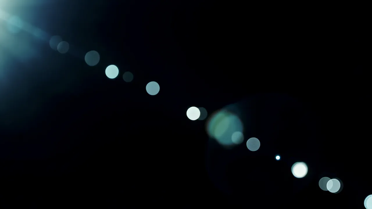 Soft Light Bloom Pulses Across Black Background