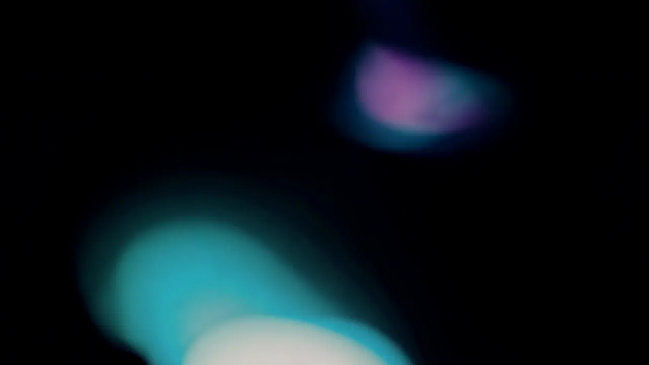 Soft Teal and Cyan Light Bloom on Black Background