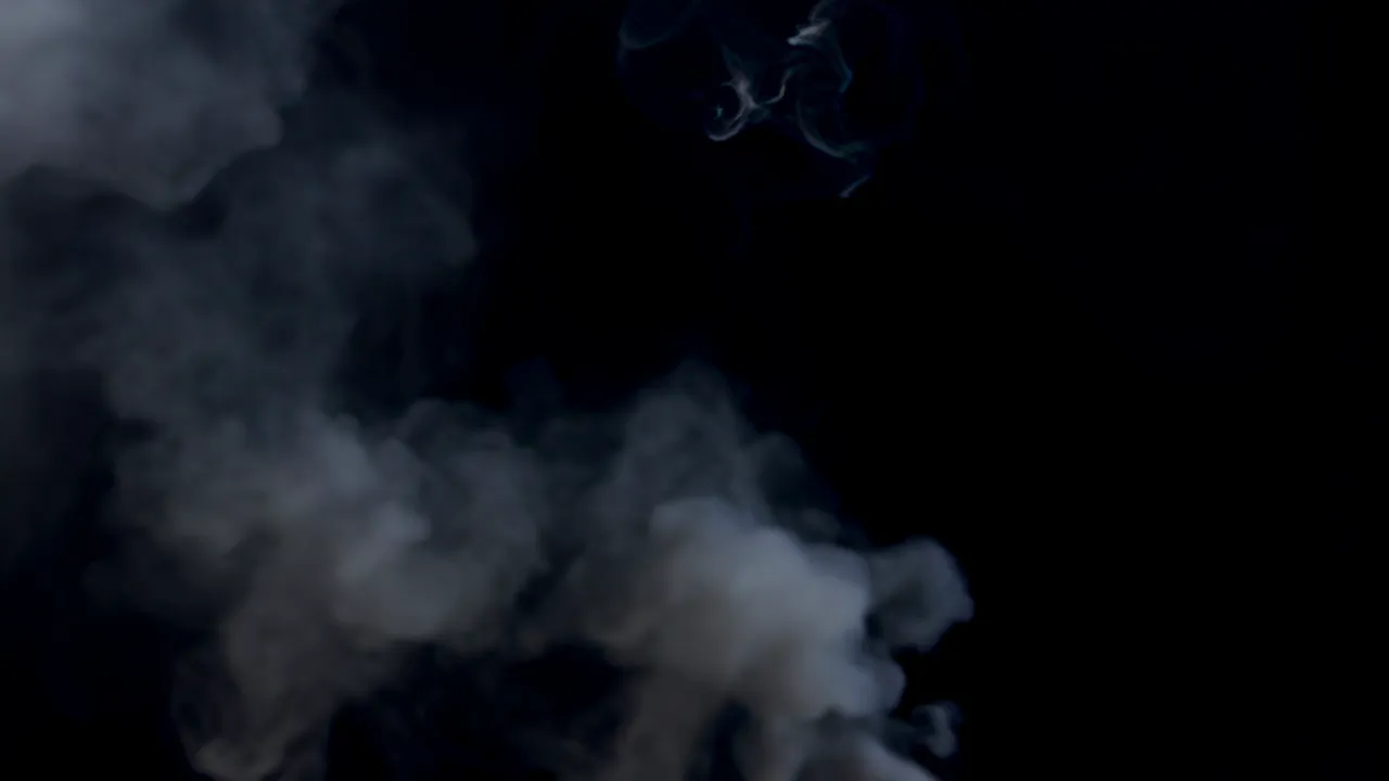 Thin Wisp of White Smoke Rising Against Black Background