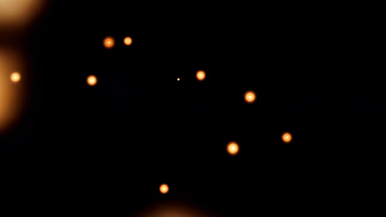 Warm Orange and Gold Bokeh Light Orbs Drifting
