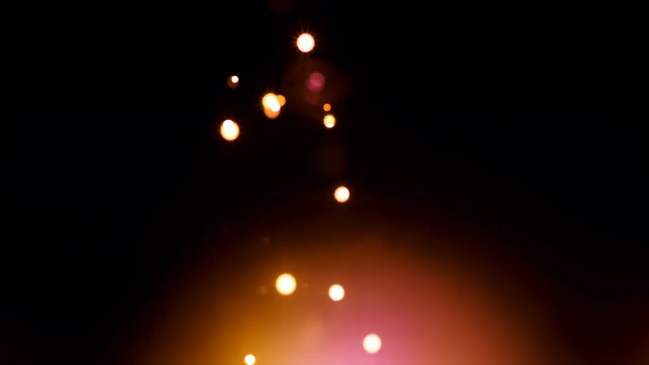 Warm Orange and Gold Bokeh Light Orbs on Black Background