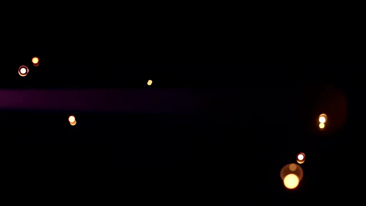 Warm Orange and Gold Bokeh Orbs Drifting in Darkness