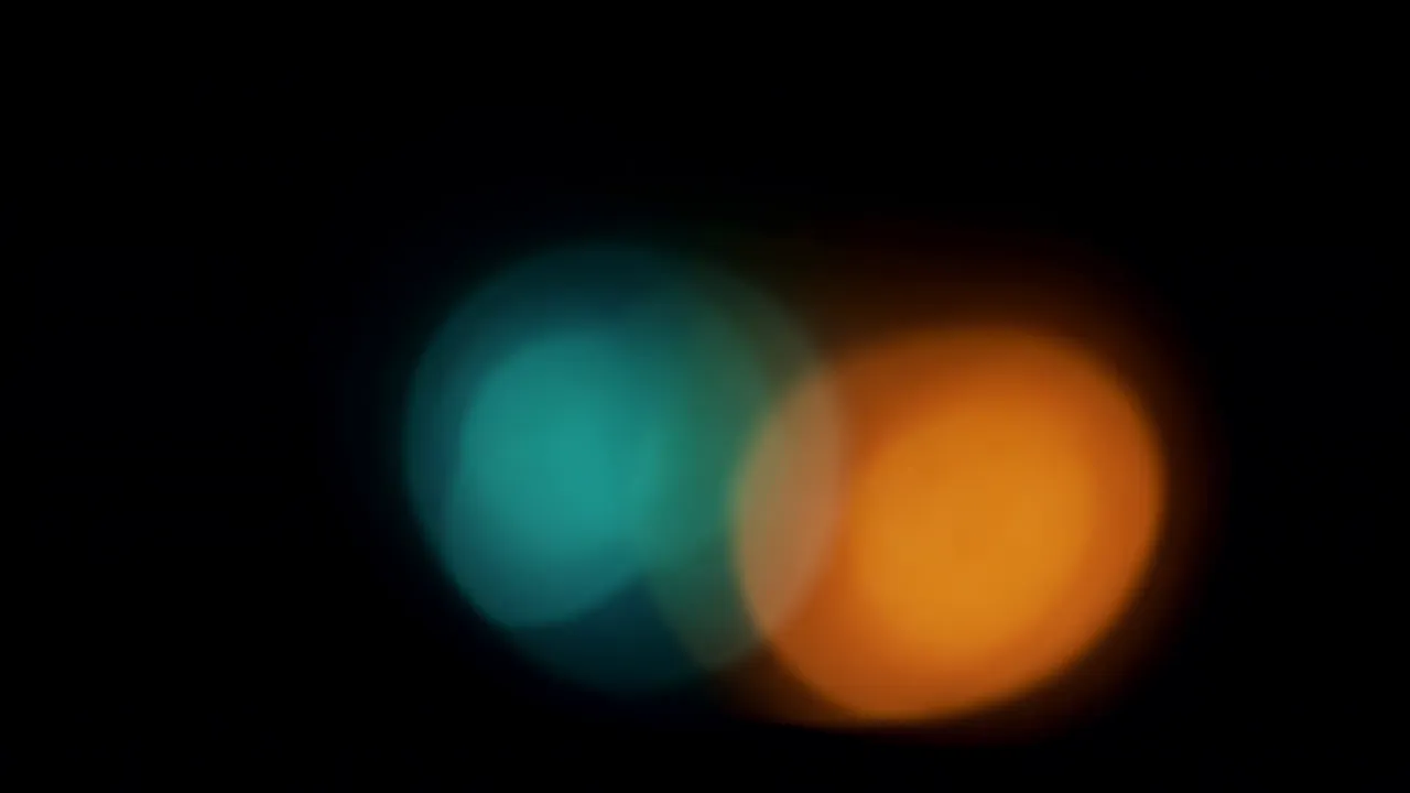 Warm Orange Light Bloom Expanding on Black Background